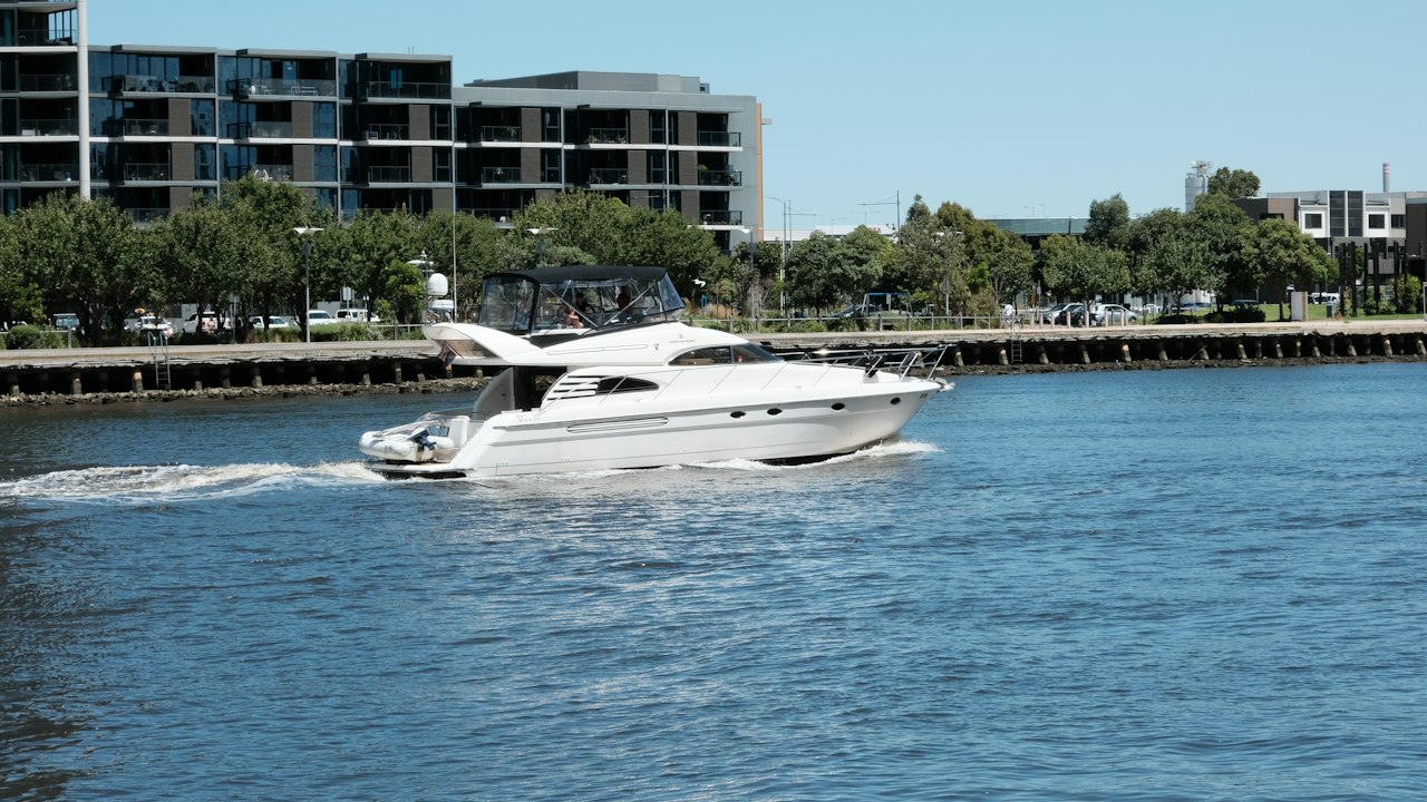 A white motor yacht cruising on blue water