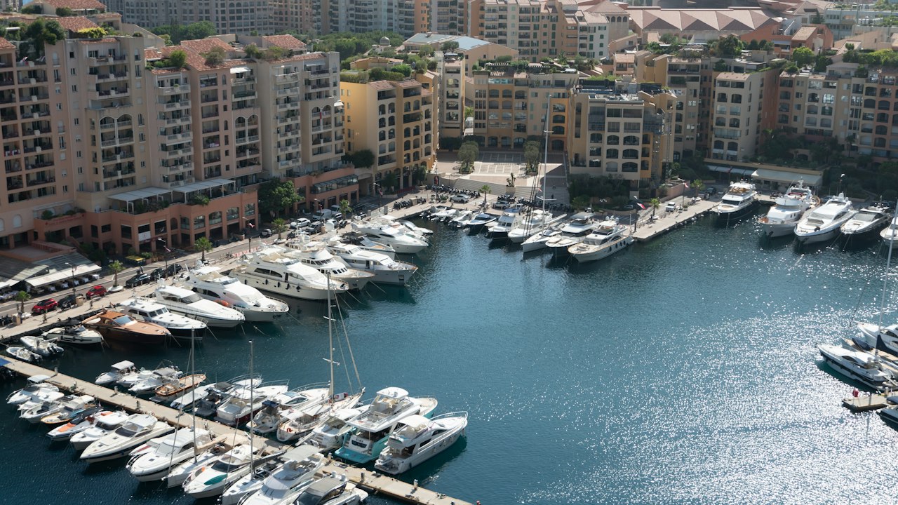 Yachts docked in a harbour with buildings behind